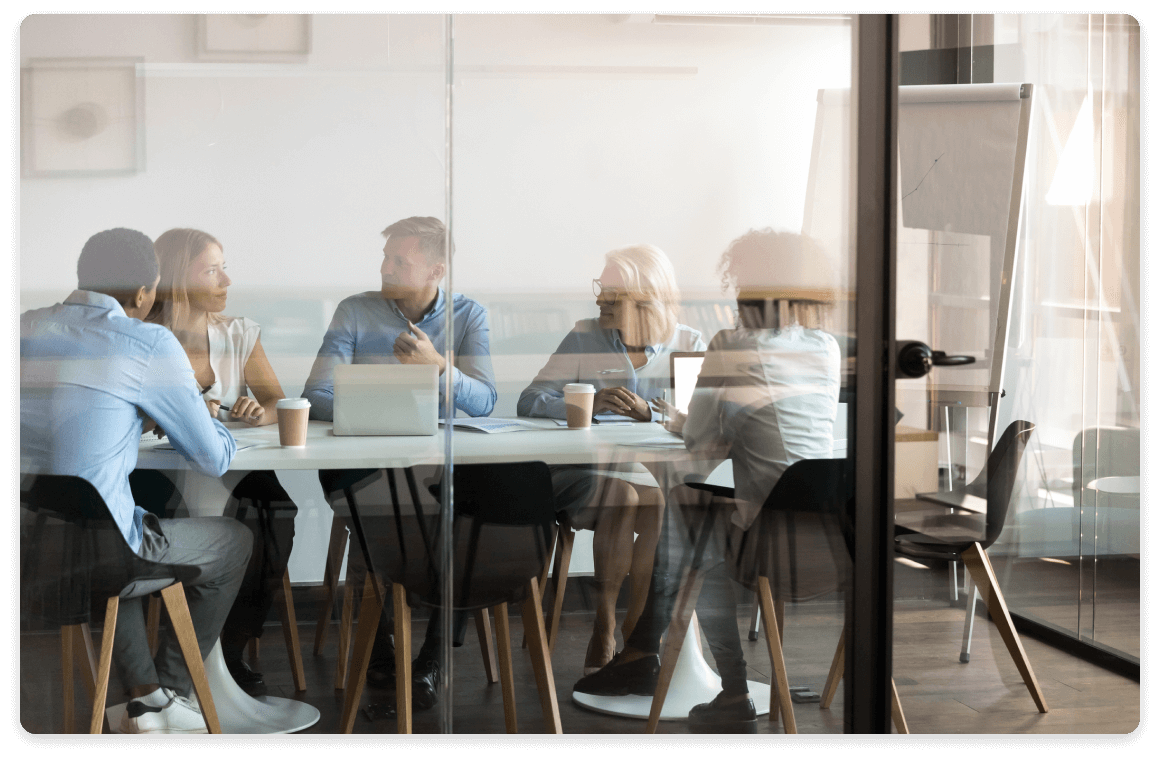 Photo of a meeting in glass walled meeting room
